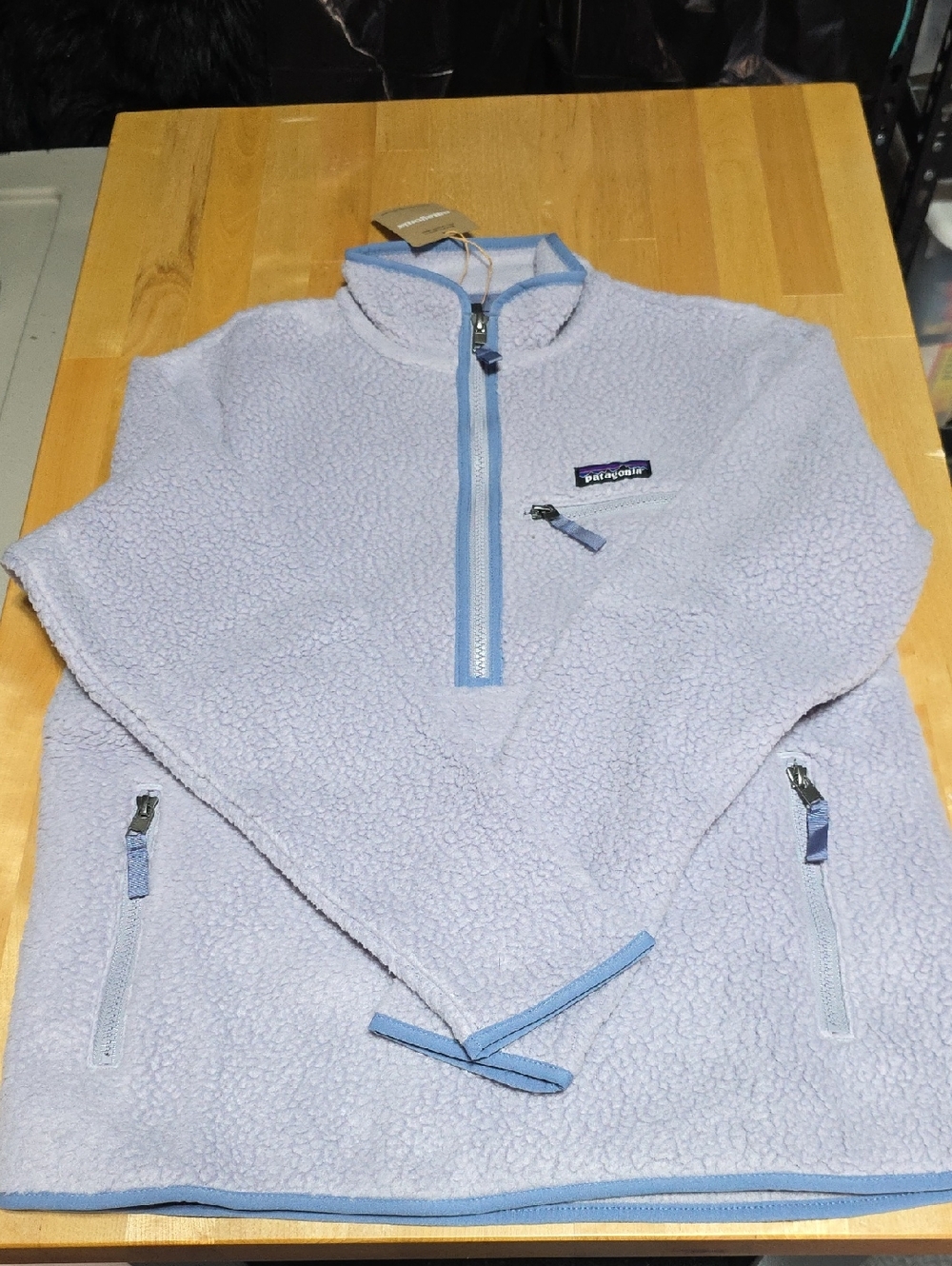 Patagonia sherpa pullover in light lavender with pale blue trim
